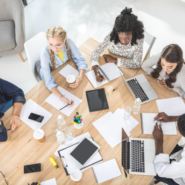 Group of employees sitting at a round table participating in team building activities